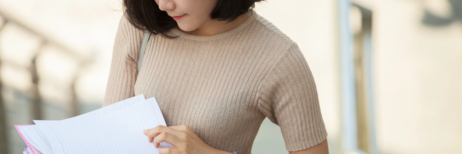 East Asian student reviewing application forms and study documents