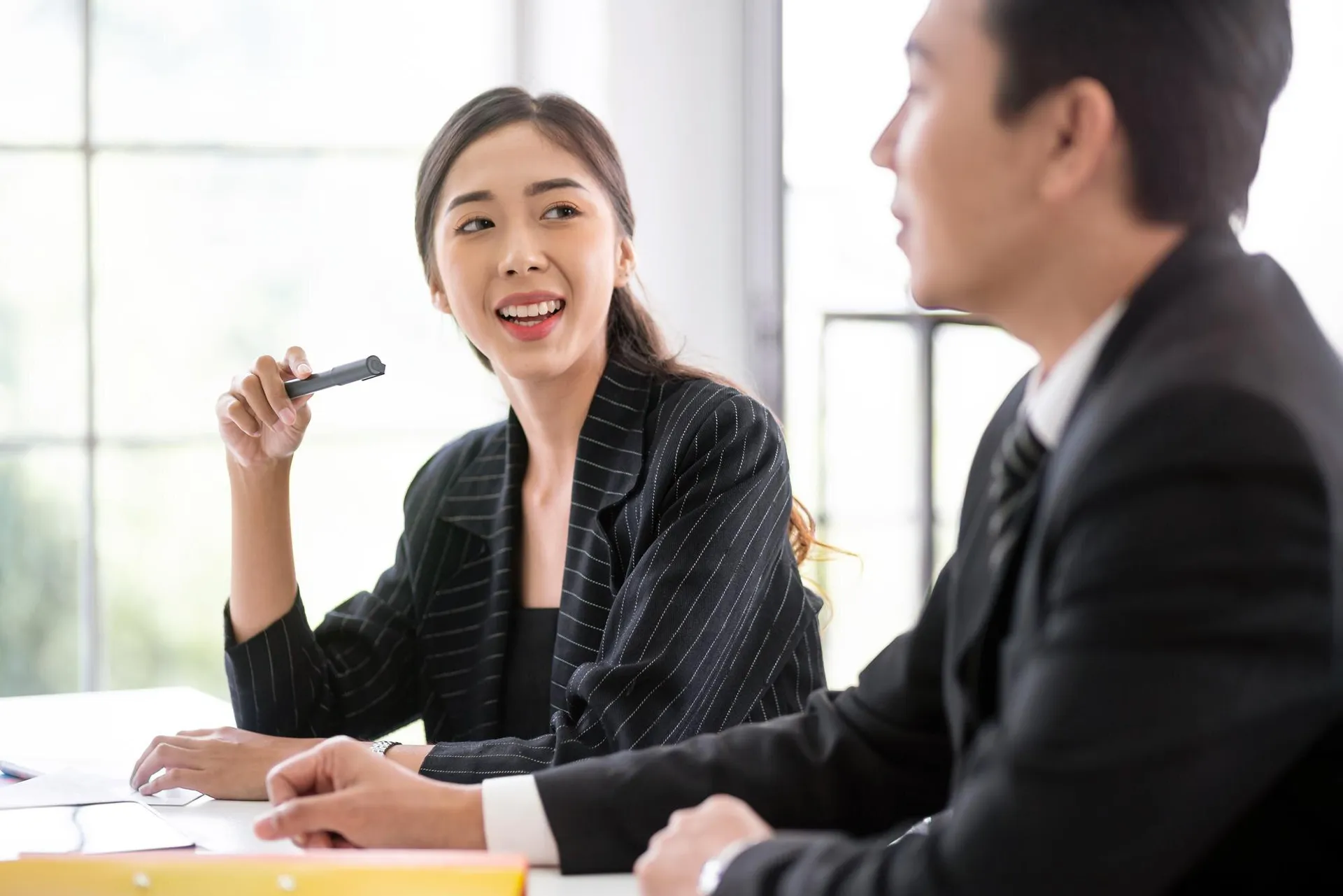 East Asian woman adviser in a professional consultation meeting