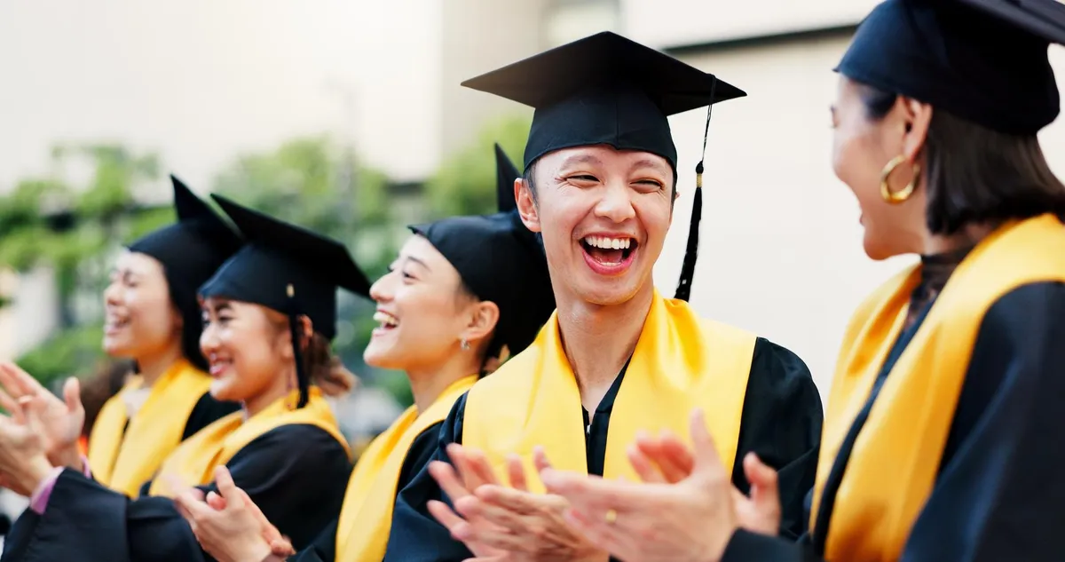East Asian graduates celebrating at a university graduation ceremony