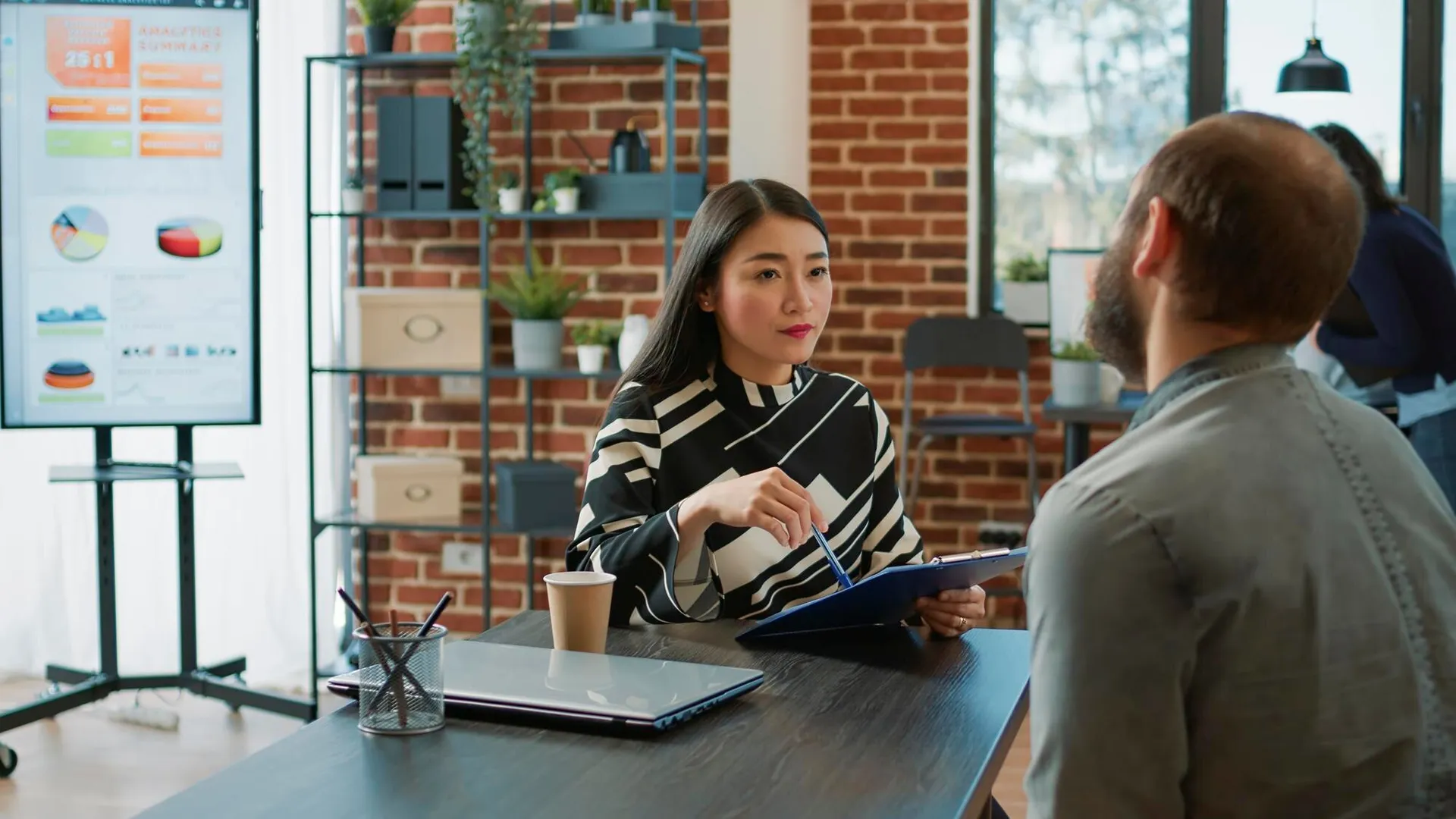 Diverse recruitment team reviewing a graduate candidate's CV and discussing a job offer