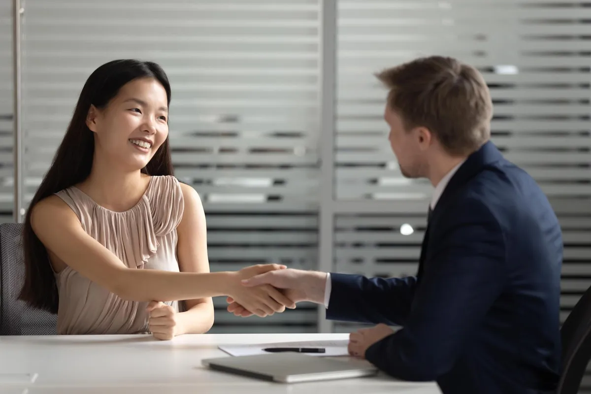 Employer and job candidate shaking hands after a successful interview