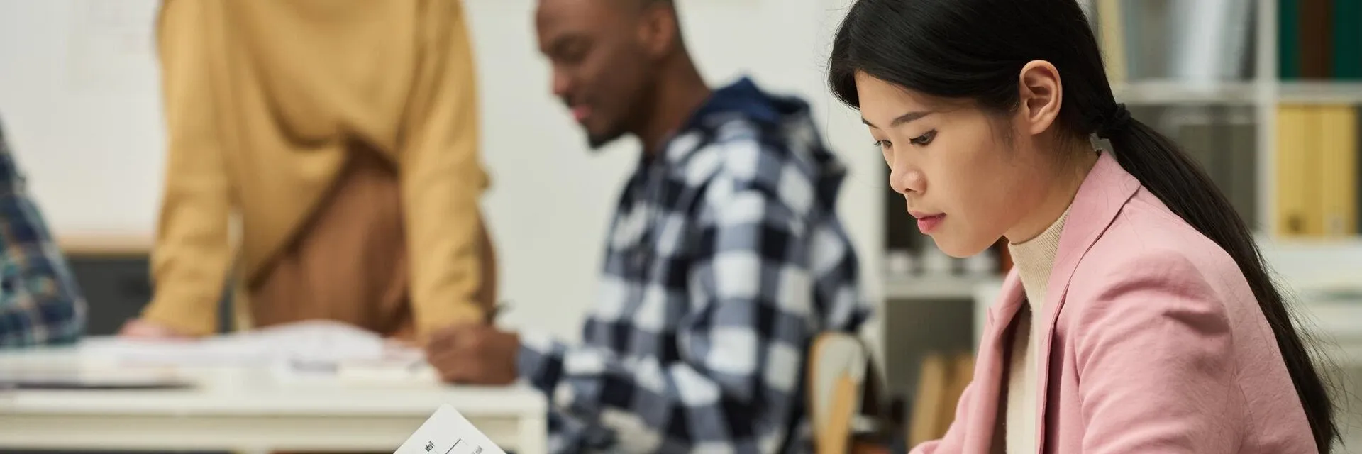 East Asian student completing an English language test in a classroom