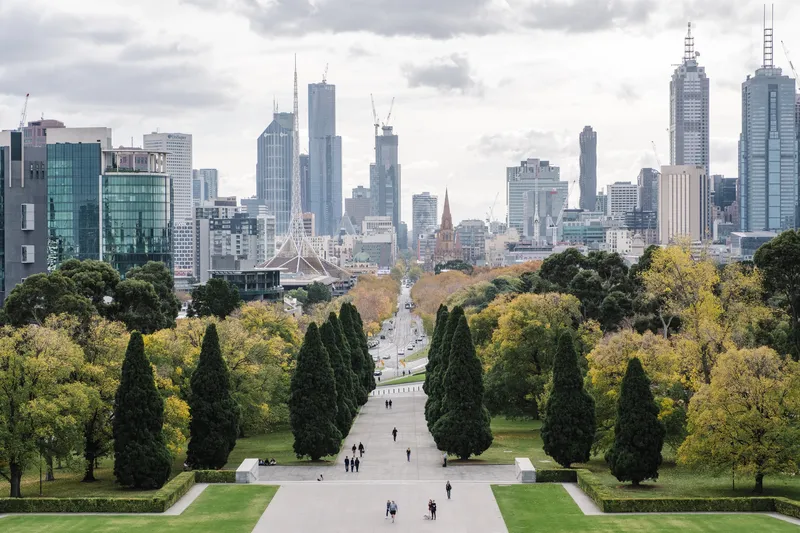 Melbourne city skyline with lush green parklands in the foreground